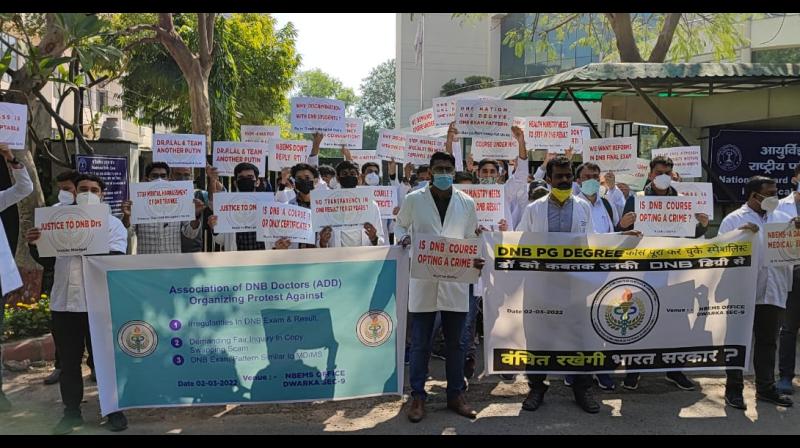 Students who have completed DNB Medical PG Degree Course protest in front of Dwarka office