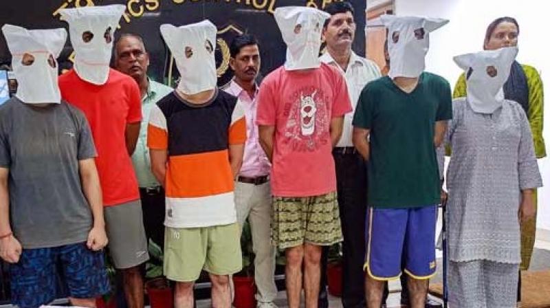 Narcotics Control Bureau officials with people arrested after the busting of a suspected drugs trafficking network operating on the dark web. Narcotics Control Bureau officials with people arrested after the busting of a suspected drugs trafficking network operating on the dark web.