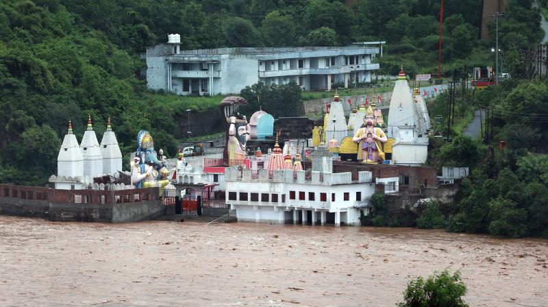 Jammu: Har ki Pauri is seen partially submerged on the banks of the swollen Tawi river after heavy monsoon rainfall, in Jammu. Jammu: Har ki Pauri is seen partially submerged on the banks of the swollen Tawi river after heavy monsoon rainfall, in Jammu.