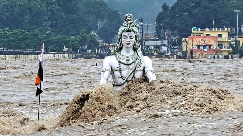 Rishikesh: An idol of Lord Shiva partially submerged in swollen Ganga river after monsoon rains, at Parmarth Niketan Ghat in Rishikesh, Monday, Aug. 14, 2023. (PTI Photo) Rishikesh: An idol of Lord Shiva partially submerged in swollen Ganga river after monsoon rains, at Parmarth Niketan Ghat in Rishikesh, Monday, Aug. 14, 2023. (PTI Photo)