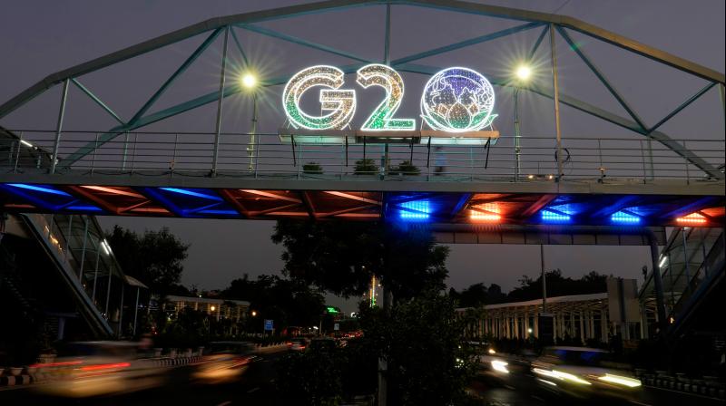 New Delhi: Vehicles move past an illuminated logo of G20 ahead of the summit, in New Delhi, Friday, Aug. 25, 2023. (PTI Photo/Manvender Vashist Lav) New Delhi: Vehicles move past an illuminated logo of G20 ahead of the summit, in New Delhi, Friday, Aug. 25, 2023. (PTI Photo/Manvender Vashist Lav)