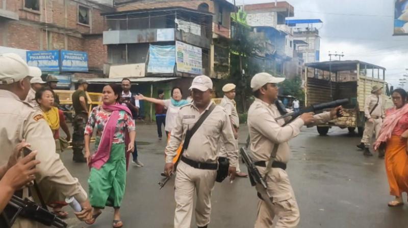 Imphal: Police try to control the situation as women stage a protest after unidentified miscreants burnt three houses, in Imphal, Sunday, Aug. 27, 2023. (PTI Photo)