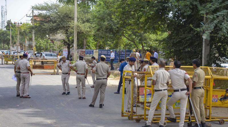 Gurugram: Police personnel stand guard ahead of a rally of Hindu organisations to be taken out in Nuh, weeks after violence in the region, in Gurugram district, Monday, Aug. 28, 2023. (PTI Photo)