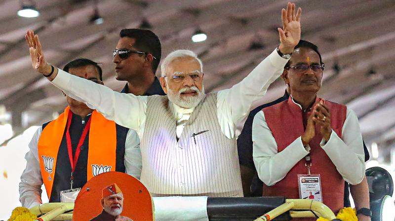 Bhopal: Prime Minister Narendra Modi waves at supporters as he arrives to address the 'Karyakarta Mahakumbh', in Bhopal, Monday, Sept. 25, 2023. Madhya Pradesh Chief Minister Shivraj Singh Chouhan and State BJP President VD Sharma are also seen. (PTI Photo)