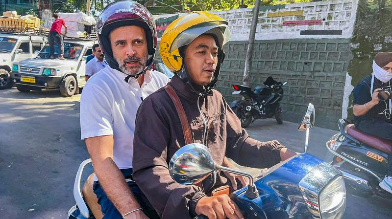 Aizawl: Congress leader Rahul Gandhi rides a two-wheeler during his visit to Mizoram ahead of upcoming State Assembly elections, in Aizawl, Tuesday, Oct. 17, 2023. (PTI Photo) Aizawl: Congress leader Rahul Gandhi rides a two-wheeler during his visit to Mizoram ahead of upcoming State Assembly elections, in Aizawl, Tuesday, Oct. 17, 2023. (PTI Photo)