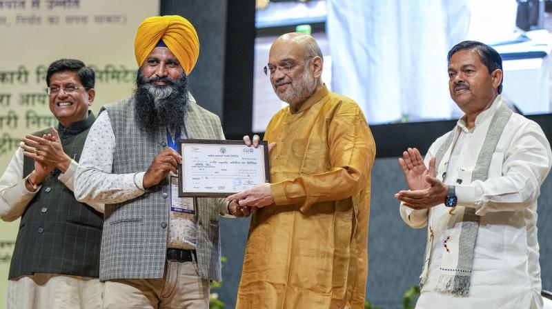 New Delhi: Union Home Minister and Minister of Cooperation Amit Shah distributes membership certificates to National Cooperative Exports Limited (NCEL) members during the National Symposium on Cooperative Exports organised by NCEL, in New Delhi, Monday, Oct. 23, 2023. Union Minister for Commerce and Industry Piyush Goyal and Union MoS of Cooperation BL Verma are also seen. (PTI Photo/Arun Sharma) New Delhi: Union Home Minister and Minister of Cooperation Amit Shah distributes membership certificates to National Cooperative Exports Limited (NCEL) members during the National Symposium on Cooperative Exports organised by NCEL, in New Delhi, Monday, Oct. 23, 2023. Union Minister for Commerce and Industry Piyush Goyal and Union MoS of Cooperation BL Verma are also seen. (PTI Photo/Arun Sharma)