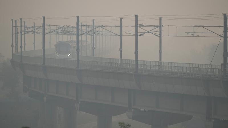 Delhi: A metro train runs on its track amid low visibility due to smog, in New Delhi, Monday, Nov. 13, 2023. The national capital recorded a jump in pollution levels and a smoky haze returned on Monday, after Diwali celebrations. (PTI Photo/Arun Sharma)
