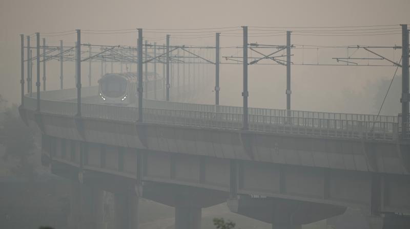 Delhi: A metro train runs on its track amid low visibility due to smog, in New Delhi, Monday, Nov. 13, 2023. The national capital recorded a jump in pollution levels and a smoky haze returned on Monday, after Diwali celebrations. (PTI Photo/Arun Sharma) Delhi: A metro train runs on its track amid low visibility due to smog, in New Delhi, Monday, Nov. 13, 2023. The national capital recorded a jump in pollution levels and a smoky haze returned on Monday, after Diwali celebrations. (PTI Photo/Arun Sharma)