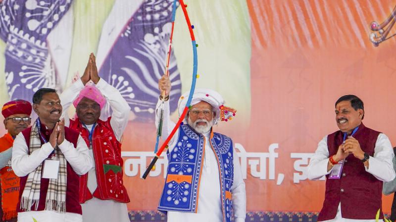 Jhabua: Prime Minister Narendra Modi with Tribal Affairs Minister Arjun Munda, Madhya Pradesh Chief Minister Mohan Yadav and others during the 'Janjatiya Sammelan' in Jhabua, Madhya Pradesh, Sunday, Feb. 11, 2023. (PTI Photo) Jhabua: Prime Minister Narendra Modi with Tribal Affairs Minister Arjun Munda, Madhya Pradesh Chief Minister Mohan Yadav and others during the 'Janjatiya Sammelan' in Jhabua, Madhya Pradesh, Sunday, Feb. 11, 2023. (PTI Photo)