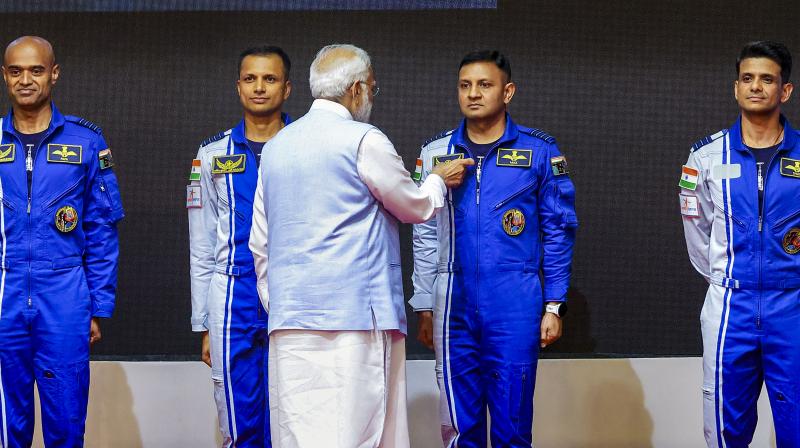 Thiruvananthapuram: Prime Minister Narendra Modi hands-over wings to astronauts-designate Shubanshu Shukla, Prashanth Balakrishnan Nair, Angad Prathap and Ajit Krishnan who have been selected to be the astronauts on India’s first crewed mission to space 'Gaganyaan Mission', at the Vikram Sarabhai Space Centre (VSSC), in Thiruvananthapuram, Tuesday, Feb. 27, 2024. (PTI Photo) Thiruvananthapuram: Prime Minister Narendra Modi hands-over wings to astronauts-designate Shubanshu Shukla, Prashanth Balakrishnan Nair, Angad Prathap and Ajit Krishnan who have been selected to be the astronauts on India’s first crewed mission to space 'Gaganyaan Mission', at the Vikram Sarabhai Space Centre (VSSC), in Thiruvananthapuram, Tuesday, Feb. 27, 2024. (PTI Photo)