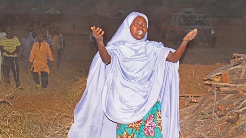 A woman cries as she calls out to the government to help rescue children kidnapped by gunmen in Chikun, Nigeria.