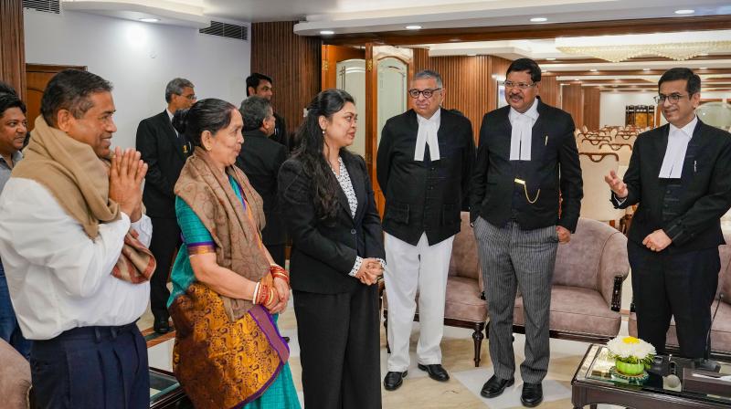 New Delhi: Pragya, who got a scholarship to study masters in law in two different universities in the US, with parents during her felicitation by the Supreme Court judges, at the Supreme Court of India in New Delhi, Wednesday, March 13, 2024. Pragya's father Ajay Kumar Samal works as a cook in Supreme Court. (PTI Photo/Shahbaz Khan) New Delhi: Pragya, who got a scholarship to study masters in law in two different universities in the US, with parents during her felicitation by the Supreme Court judges, at the Supreme Court of India in New Delhi, Wednesday, March 13, 2024. Pragya's father Ajay Kumar Samal works as a cook in Supreme Court. (PTI Photo/Shahbaz Khan)