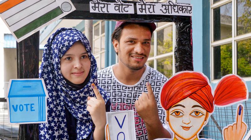 Ghaziabad: People pose for photos at a selfie point after casting their votes for the second phase of Lok Sabha elections, in Ghaziabad, Friday, April 26, 2024. (PTI Photo)
