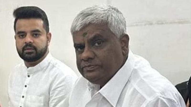 Prajwal Revanna with father H D Revanna. Prajwal Revanna with father H D Revanna.
