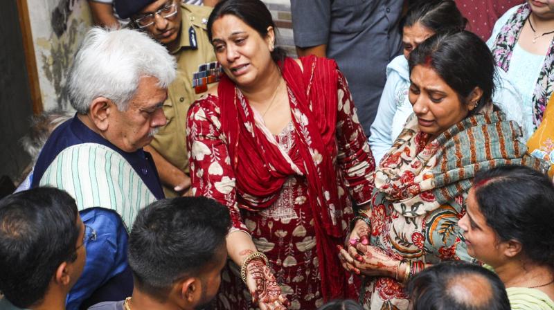 Jammu: Jammu and Kashmir Lieutenant Governor Manoj Sinha meets the family members of Shashi Bhushan Abrol, who was killed in a terrorist attack in J&K's Ganderbal on Sunday, in Jammu, Monday, Oct. 21, 2024. (PTI Photo) Jammu: Jammu and Kashmir Lieutenant Governor Manoj Sinha meets the family members of Shashi Bhushan Abrol, who was killed in a terrorist attack in J&K's Ganderbal on Sunday, in Jammu, Monday, Oct. 21, 2024. (PTI Photo)