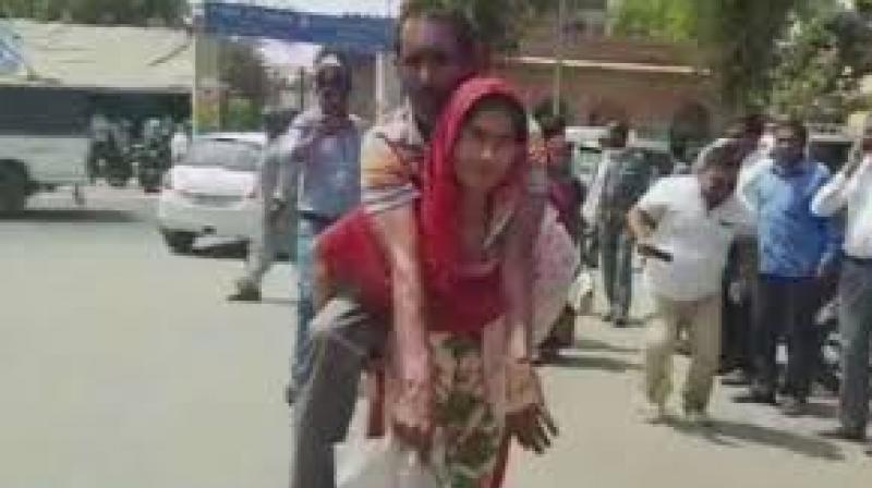 Woman carried her disable Husband on her back to CMO Office