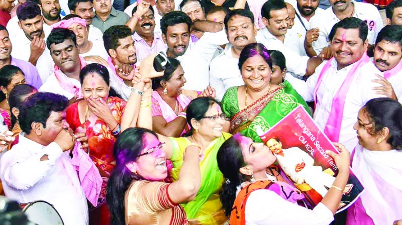 Workers expressing happiness at winning the TRS party in Hyderabad.