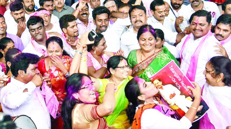 Workers expressing happiness at winning the TRS party in Hyderabad. Workers expressing happiness at winning the TRS party in Hyderabad.
