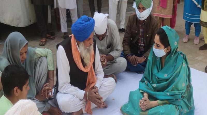 Harsimrat Badal with farmer's Family Harsimrat Badal with farmer's Family