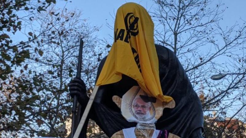 Khalistan flag draped over Mahatma Gandhi statue near Indian embassy in us Khalistan flag draped over Mahatma Gandhi statue near Indian embassy in us