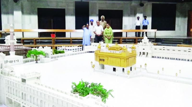 Looking at the model of Darbar Sahib in Plaza Looking at the model of Darbar Sahib in Plaza