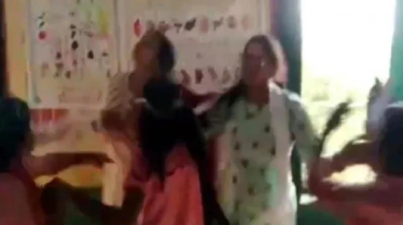 The female teacher grabbed the principal in the classroom