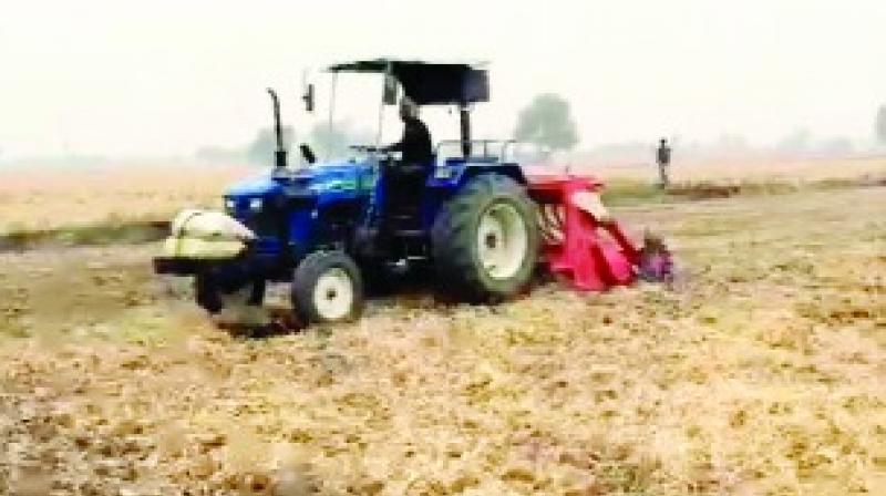 The story of Harmeet Singh, a progressive farmer plowing paddy stubble in the field