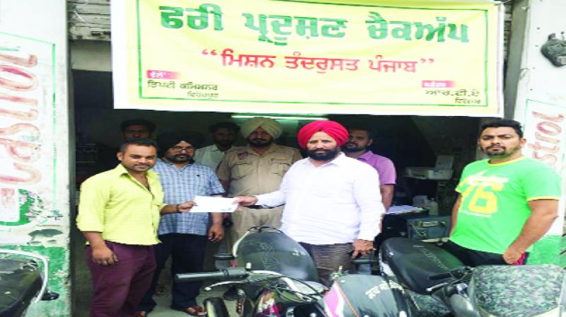 Jaswant Singh Dhillon Distributing Pollution Checkup Certificates 