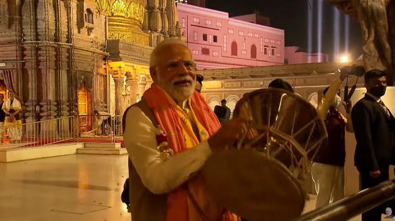 PM Modi tries his hand at 'damru' at Kashi Vishwanath Temple in Varanasi PM Modi tries his hand at 'damru' at Kashi Vishwanath Temple in Varanasi