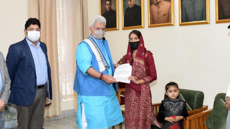 LG hands over appointment letter to wife of teacher killed by terrorists in Kashmir