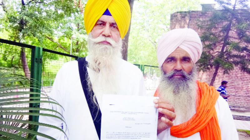 Baldev Singh Sarsa showing the copy of the Center issued notification.