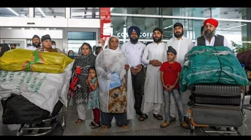 File photo of Afghan Sikhs arriving at Delhi's Airport from Kabul. File photo of Afghan Sikhs arriving at Delhi's Airport from Kabul.