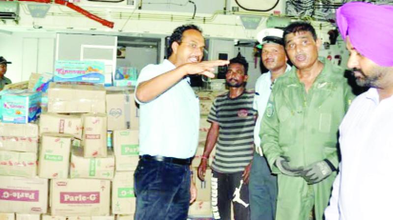 Officers carrying relief material on aircraft