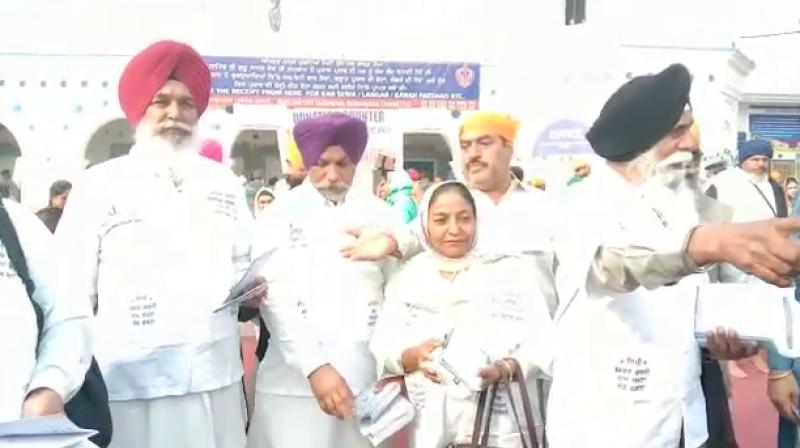 Sikh distribute religious book Sikh distribute religious book