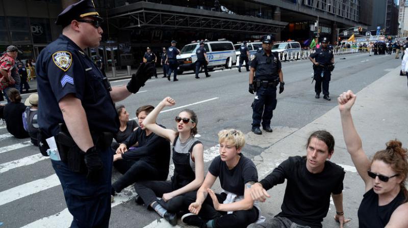 Police arrest 70 climate change protesters outside New York Times Police arrest 70 climate change protesters outside New York Times