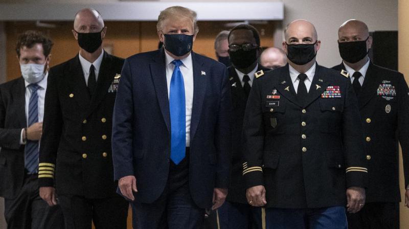 Donald Trump wears a mask for the first time in public
