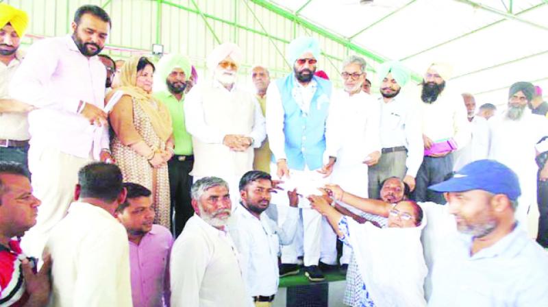 Distributing The Check To Panchayat Members By Rana Sodhi Distributing The Check To Panchayat Members By Rana Sodhi