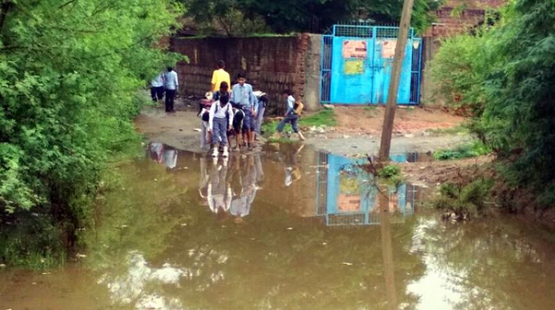 850 children go to school like this in the midst of dirty water