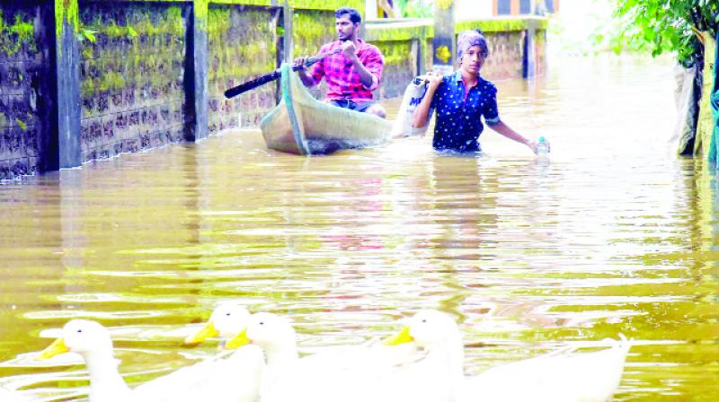 People passing through standing water due to flood