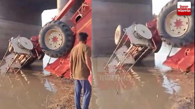 overturned combine in the canal