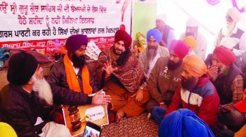 Navjot sidhu With families of the deceased and Ajit Singh at Behbal Kalan Dharna Navjot sidhu With families of the deceased and Ajit Singh at Behbal Kalan Dharna