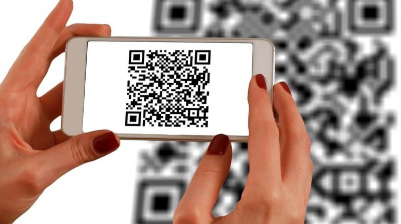 A QR code is displayed on the ATM screen to withdraw money. A QR code is displayed on the ATM screen to withdraw money.