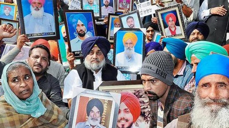 SAD president Sukhbir Singh Badal with the kin of farmers who committed suicide, in Chandigarh