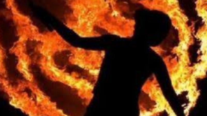 Dalit youth set on fire