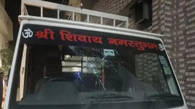 Youth vandalizing the vehicle with bricks and stones