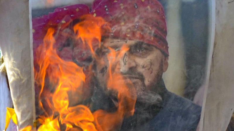 Supporters of wrestlers protesting against the Wrestling Federation of India (WFI) President Brij Bhushan Sharan Singh burn his poster during a protest march, in Gurugram.