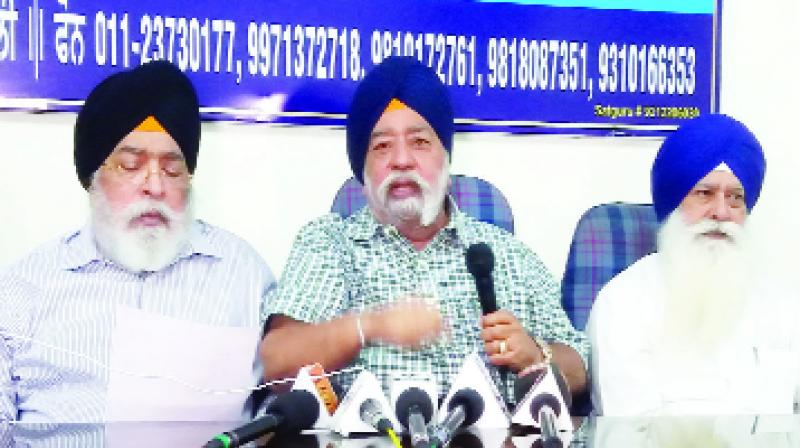 Paramjit Singh Sarna and others discussing with Journalists