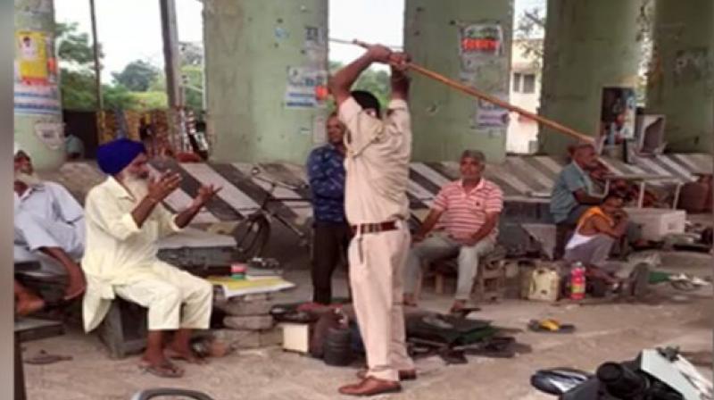 Cop seen thrashing elderly Sikh man with stick in viral video, suspended Cop seen thrashing elderly Sikh man with stick in viral video, suspended