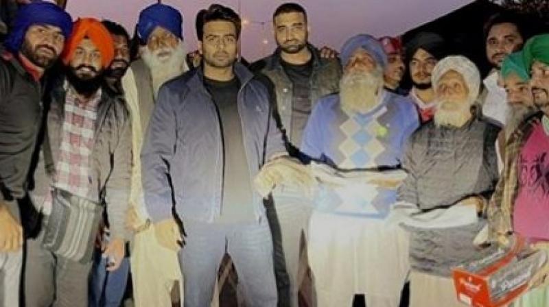 Mankirt Aulakh distributes boots and warm shawls to elderly women and farmers Mankirt Aulakh distributes boots and warm shawls to elderly women and farmers