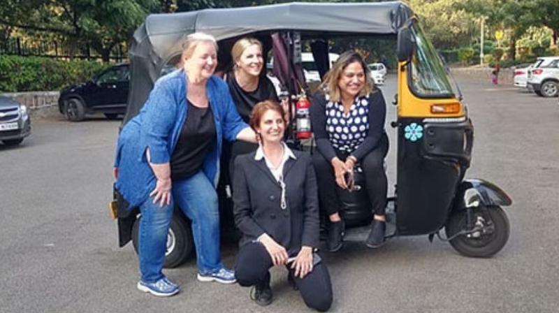 US womens driving autos on the road of delhi